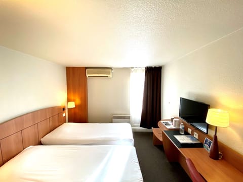 Premium bedding, desk, laptop workspace, blackout drapes