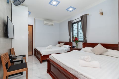 Family Quadruple Room | Minibar, in-room safe, desk, blackout drapes