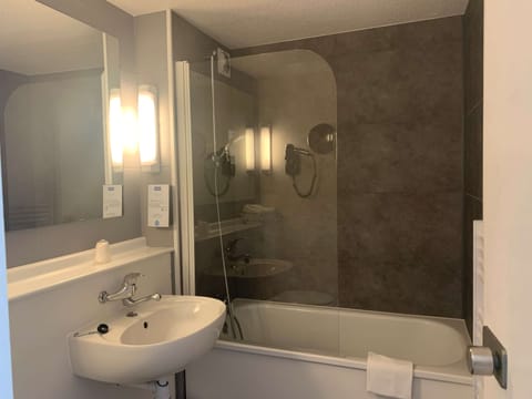 Bathtub, eco-friendly toiletries, hair dryer, towels