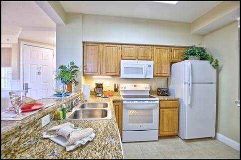 Microwave, coffee/tea maker, cookware/dishes/utensils, cleaning supplies