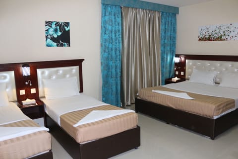 Family Room | Minibar, in-room safe, desk, blackout drapes