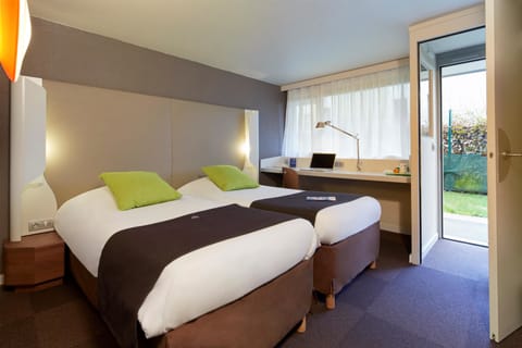 Premium bedding, desk, laptop workspace, blackout drapes