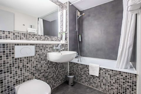 Bathtub, eco-friendly toiletries, towels