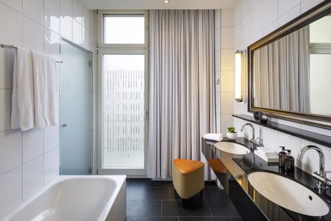 Opera Deluxe | Bathroom | Eco-friendly toiletries, hair dryer, slippers, towels