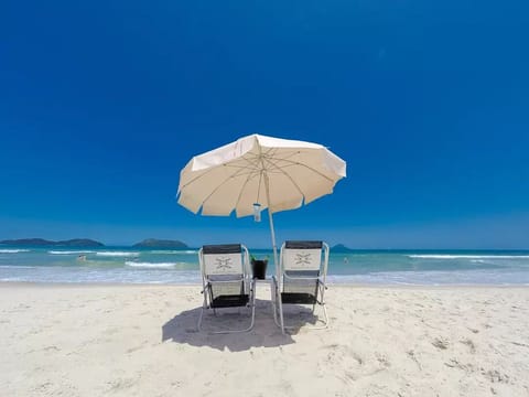 On the beach, white sand, sun loungers, beach umbrellas