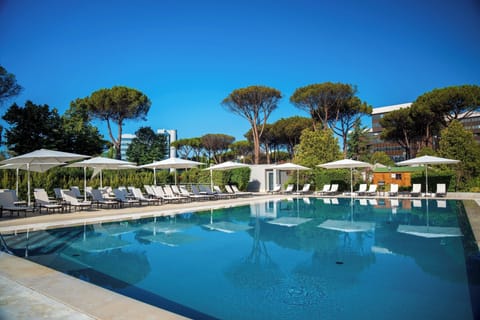 Seasonal outdoor pool, open 10:00 AM to 8:00 PM, pool umbrellas