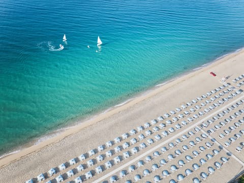 Private beach, sun loungers, beach umbrellas, windsurfing