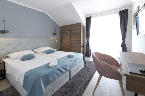 Double or Twin Room, Partial Sea View | Minibar, in-room safe, desk, blackout drapes