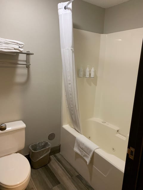 Suite, 1 King Bed, Non Smoking, Jetted Tub | Bathroom | Combined shower/tub, hair dryer, towels