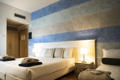 Superior Triple Room | Minibar, in-room safe, desk, laptop workspace