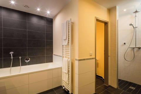 Premium Suite, 1 King Bed (Cozy Sitting Corner) | Bathroom | Hair dryer, towels, soap, shampoo