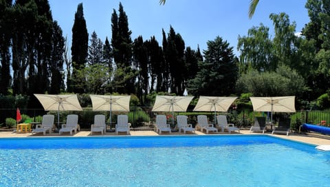 Seasonal outdoor pool, open 9:00 AM to 8:00 PM, pool umbrellas