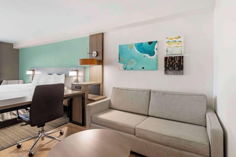 Premium bedding, desk, laptop workspace, blackout drapes