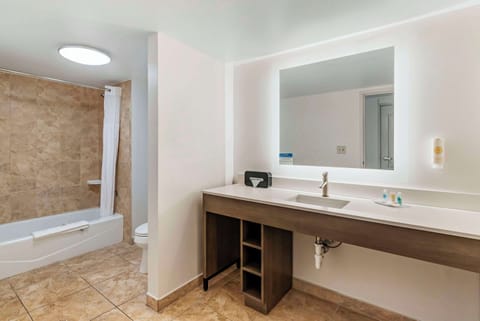 Premium bedding, desk, laptop workspace, blackout drapes