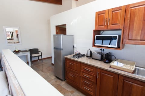 Luxury Suite, 1 Bedroom | Private kitchenette | Full-size fridge, microwave, stovetop, coffee/tea maker