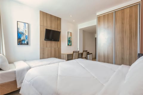 Superior Triple Room | Minibar, in-room safe, desk, blackout drapes