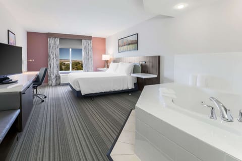 King Room, Jetted Tub | Bathroom | Combined shower/tub, free toiletries, hair dryer, towels