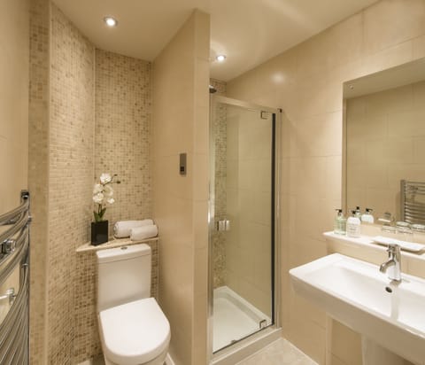 Shower, designer toiletries, hair dryer, towels