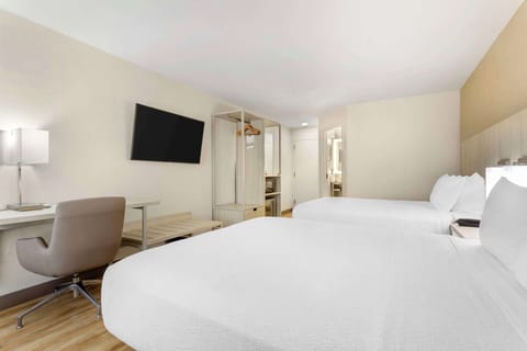 Premium bedding, desk, laptop workspace, blackout drapes