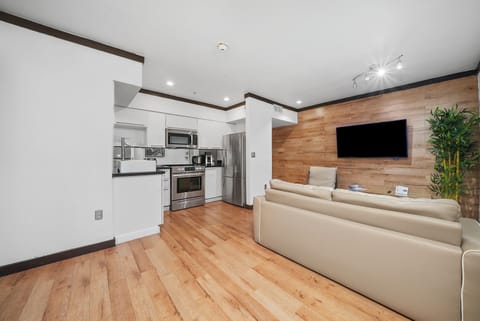 Deluxe One Bedroom King Suite | Living area | 42-inch plasma TV with cable channels, TV, iPod dock