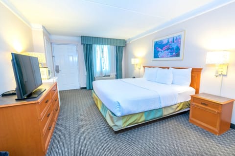 Premium bedding, desk, laptop workspace, blackout drapes