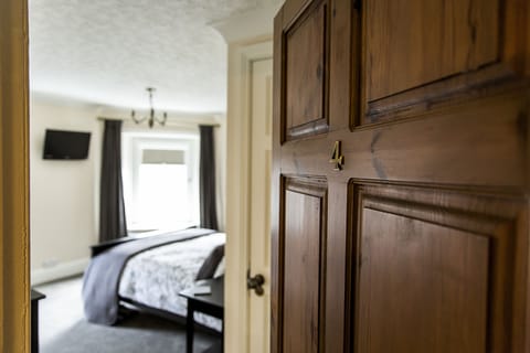 Deluxe Double Room (Room 4) | Premium bedding, desk, laptop workspace, iron/ironing board
