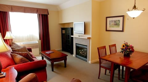 Suite, 1 King Bed, Sofa Bed & Full Kitchen | Living room | Flat-screen TV