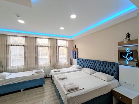 Luxury Quadruple Room | Premium bedding, minibar, desk, blackout drapes