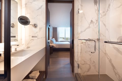 Deluxe Room, 1 King Bed, City View | Bathroom | Rainfall showerhead, designer toiletries, hair dryer, bathrobes