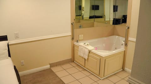 Room, 1 King Bed, Jetted Tub | Iron/ironing board, rollaway beds, free WiFi, bed sheets