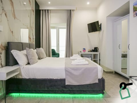 Quadruple Room | Down comforters, in-room safe, desk, laptop workspace