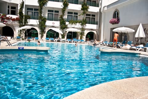 Seasonal outdoor pool, open 10:00 AM to 7:00 PM, pool umbrellas