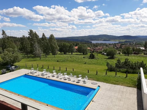Seasonal outdoor pool, open 9:00 AM to 9:00 PM, pool umbrellas