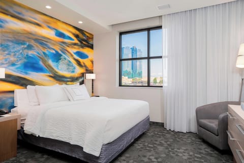 Premium bedding, desk, laptop workspace, blackout drapes