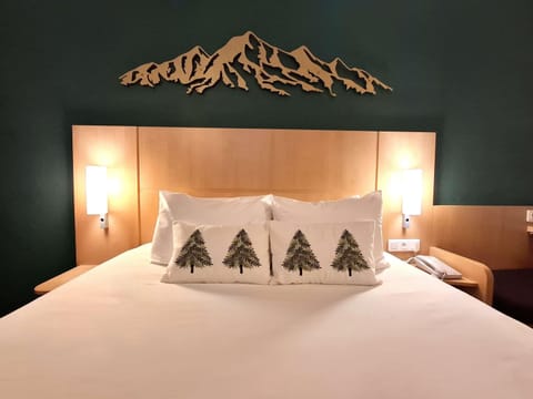 Premium bedding, desk, laptop workspace, blackout drapes