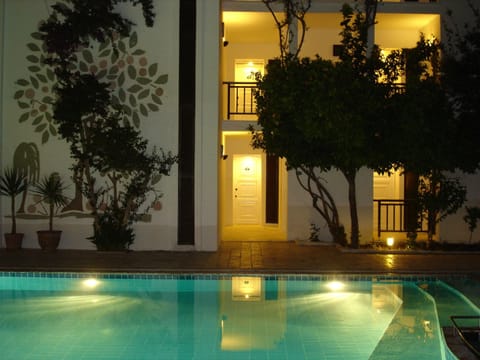 Outdoor pool, a waterfall pool, pool umbrellas, sun loungers