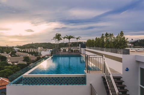 Outdoor pool, a rooftop pool, pool umbrellas, sun loungers