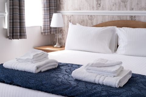 Desk, iron/ironing board, bed sheets