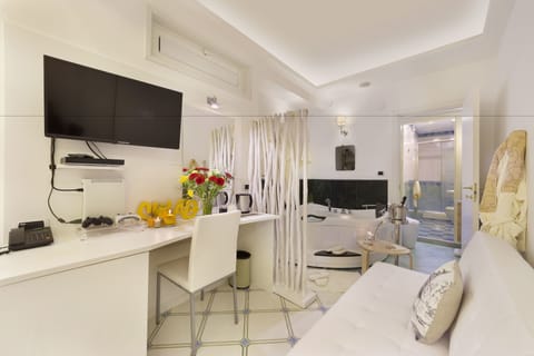 Junior Suite, Jetted Tub | Living area | 32-inch flat-screen TV with digital channels, TV, video-game console