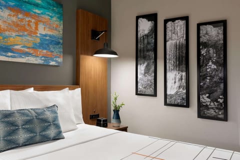 Premium bedding, desk, laptop workspace, blackout drapes