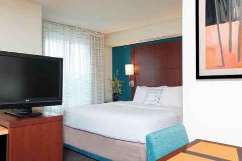 Hypo-allergenic bedding, desk, laptop workspace, blackout drapes