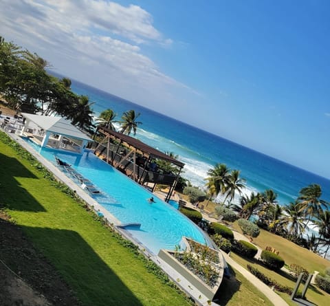 Outdoor pool, open 7:00 AM to 10:00 PM, pool umbrellas, sun loungers
