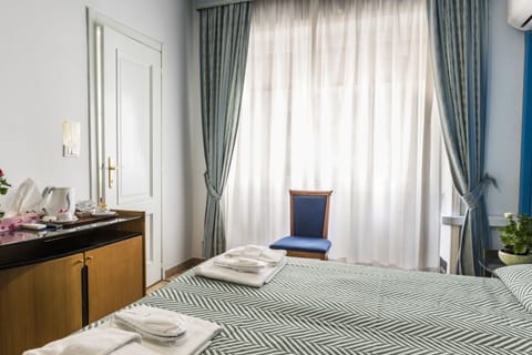 Standard Quadruple Room | In-room safe, desk, iron/ironing board