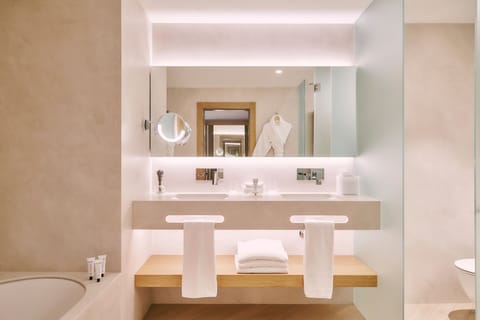 Junior Suite | Bathroom | Shower, designer toiletries, hair dryer, bathrobes