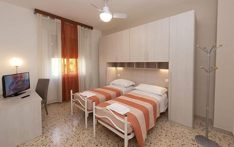 Economy Double or Twin Room | Desk, blackout drapes, iron/ironing board, cribs/infant beds