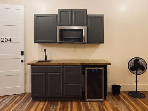 Luxury Studio, 1 Queen Bed (204) | Private kitchenette | Mini-fridge, coffee/tea maker, highchair