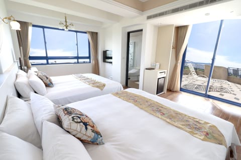 Deluxe Quadruple Room, Ocean View | Desk, blackout drapes, soundproofing, free WiFi