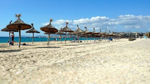 Beach nearby, white sand, sun loungers