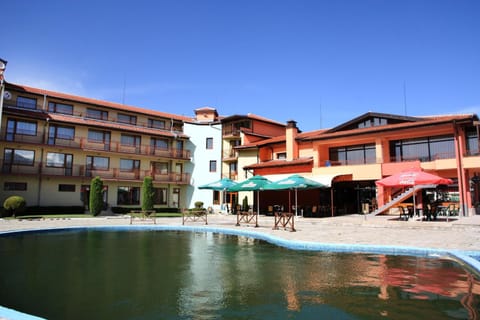 Seasonal outdoor pool, open 7:30 AM to 7:30 PM, pool umbrellas