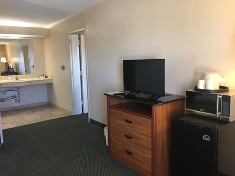 Premium bedding, desk, laptop workspace, blackout drapes